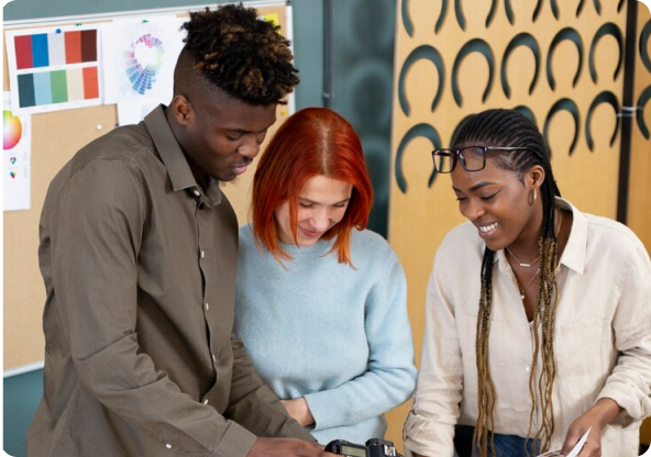 Three people looking at something.