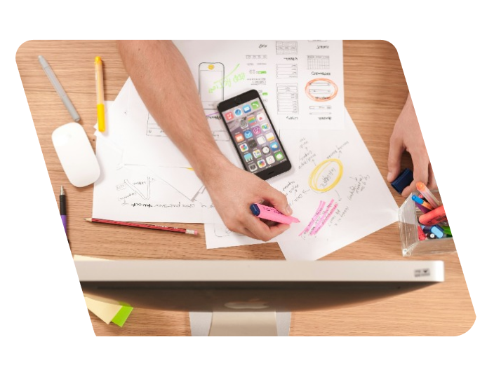 A person with papers and a tablet planning