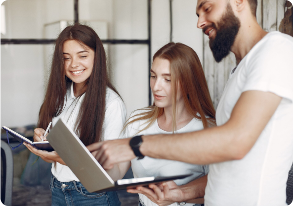 Three people looking at a notebook