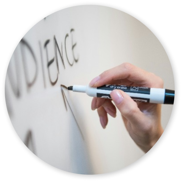 One person writing on a whiteboard