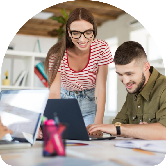 Two people looking at a notebook